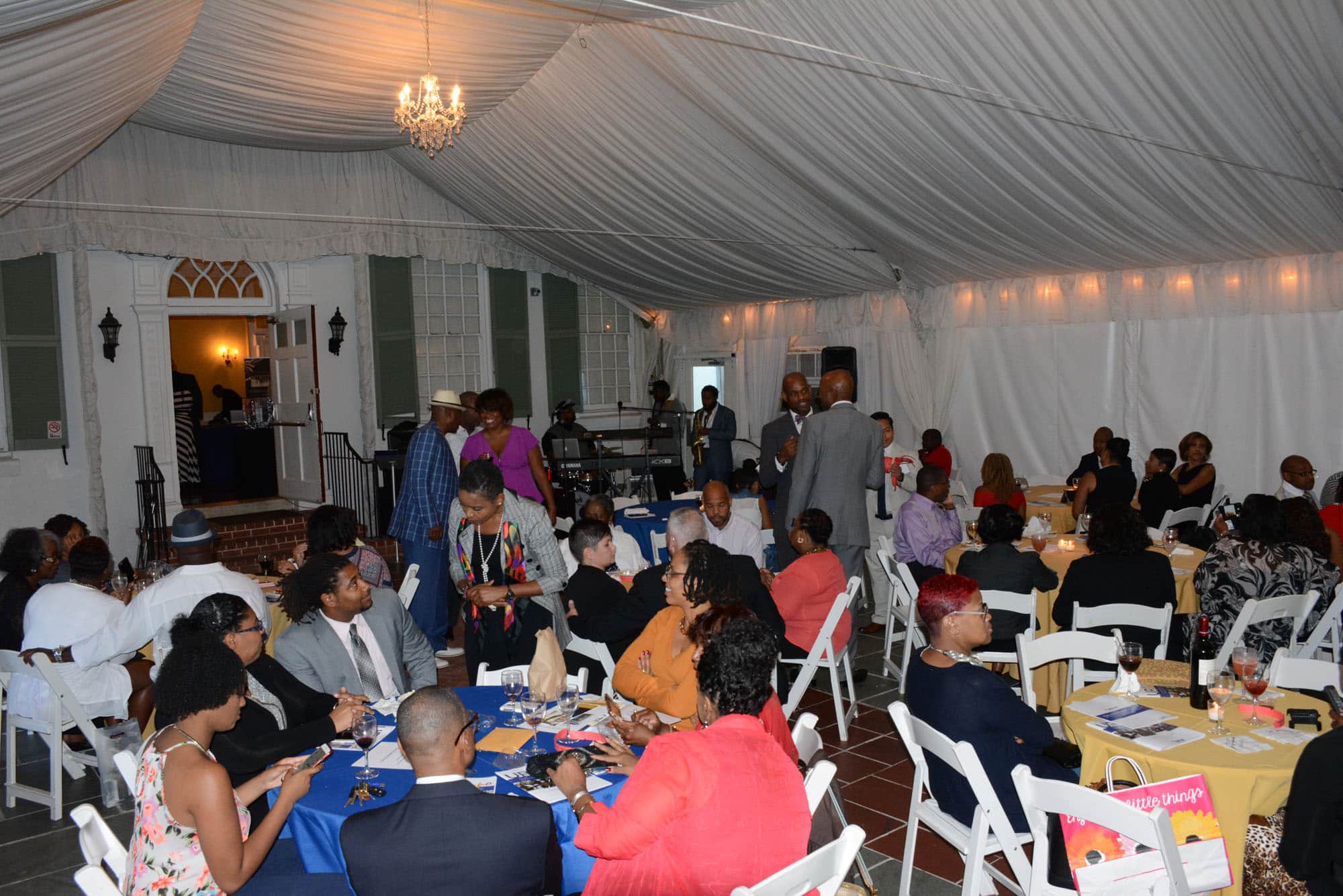 Then, they relaxed under a tent behind the mansion to listen to Marcus Johnson and the Urban Jam Band.