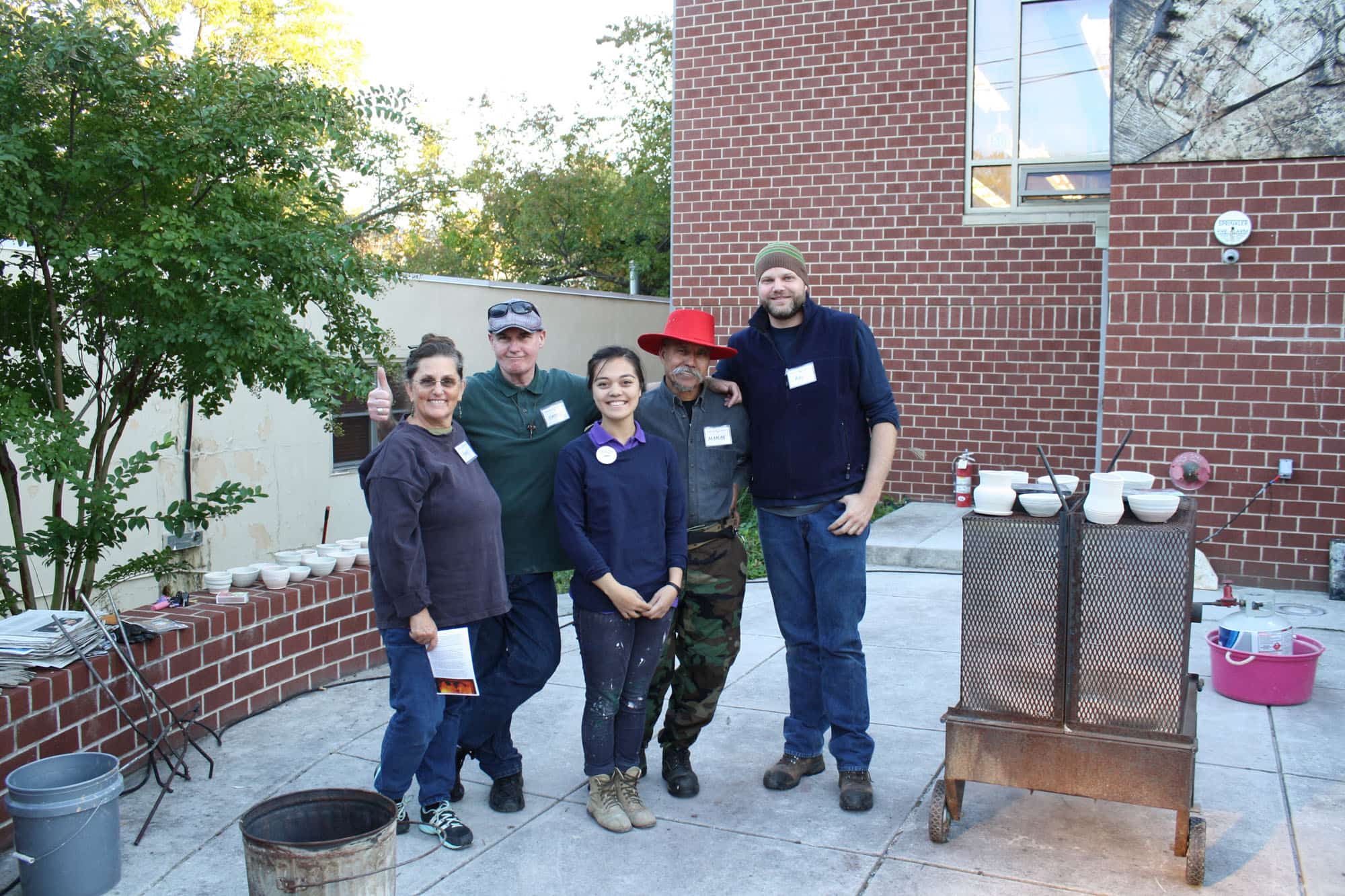 Pictured (LtoR) Terry Whye, Patrick Caughy, Emma Chin;,Maman Riken, Ray Henry - Baltimore Clayworks raku volunteers all! (Photo courtesy KC Corbett, Baltimore Clayworks marketing coordinator)